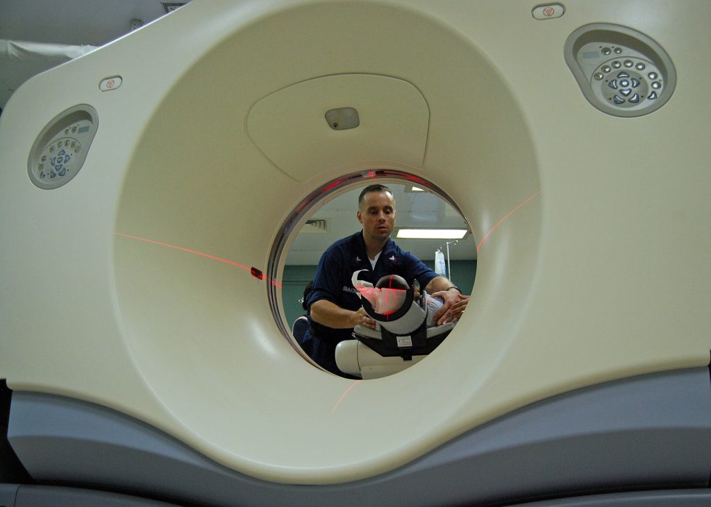 A patient undergoing a CT scan at a hospital
